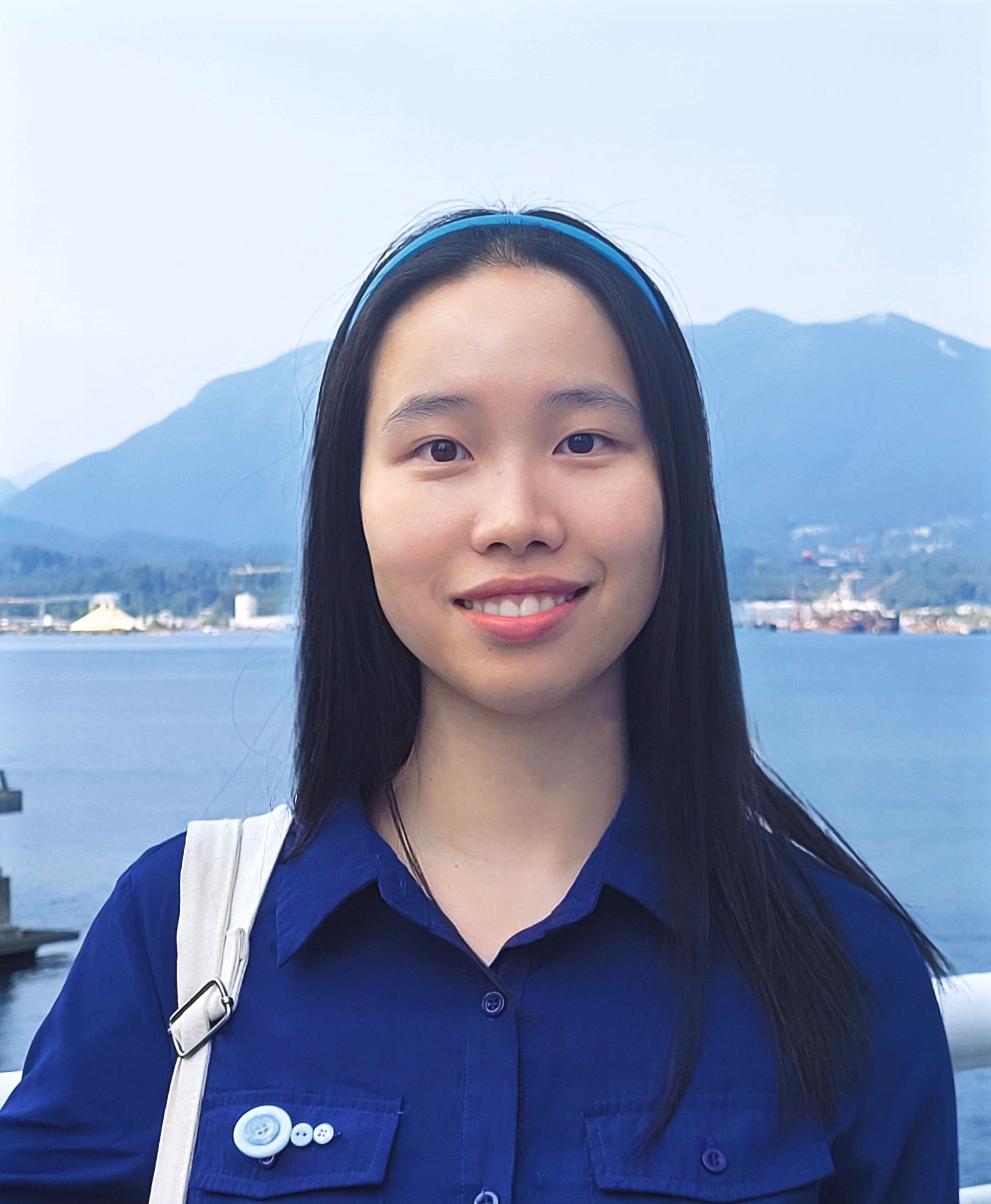 headshot of a smiley girl wearing blue blouse